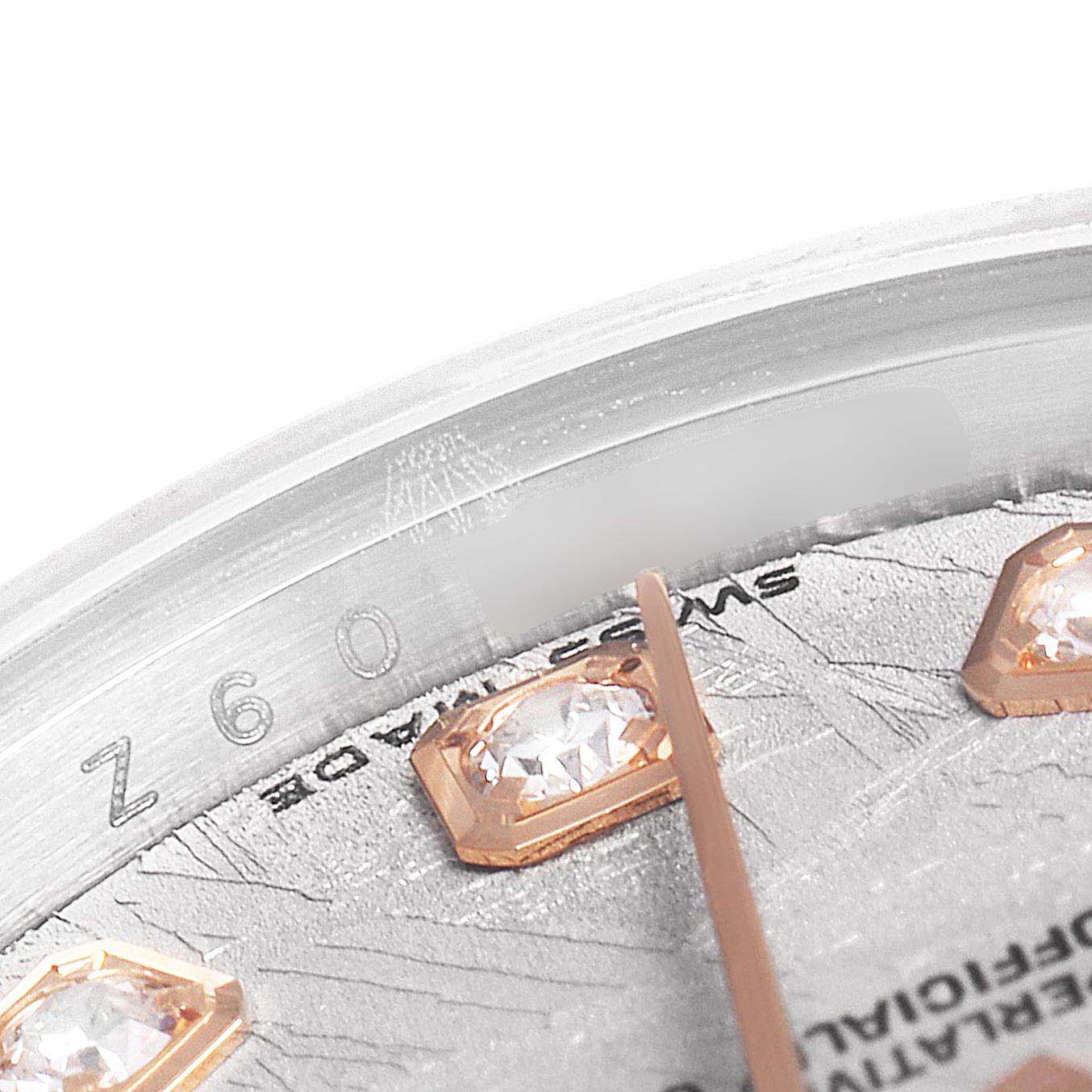 The image shows a close-up angle of the Rolex Datejust 179171 Women's Steel and Gold (two tone) Silver Dial 179171 Women's Steel and Gold (two tone) Silver Dial watch's dial with diamond markers and part of the flange and hand.