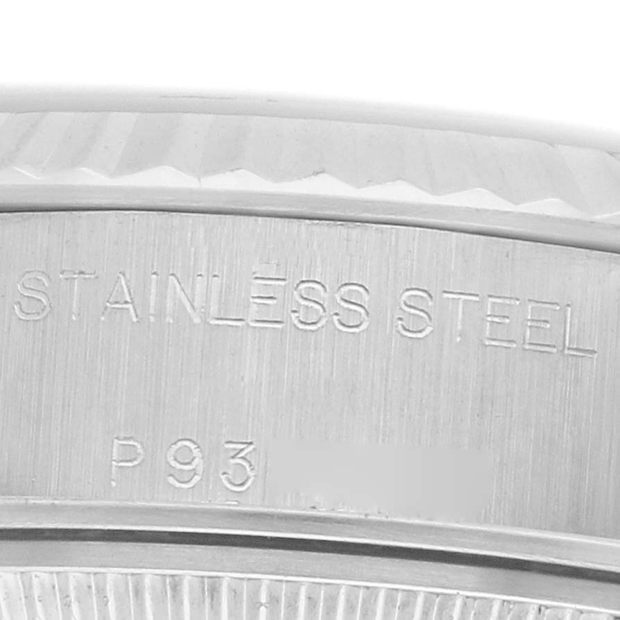 The image shows a close-up of the case side of a Rolex Datejust 79174 Women
s Stainless Steel Mother of Pearl Dial, highlighting the "STAINLESS STEEL" engraving.