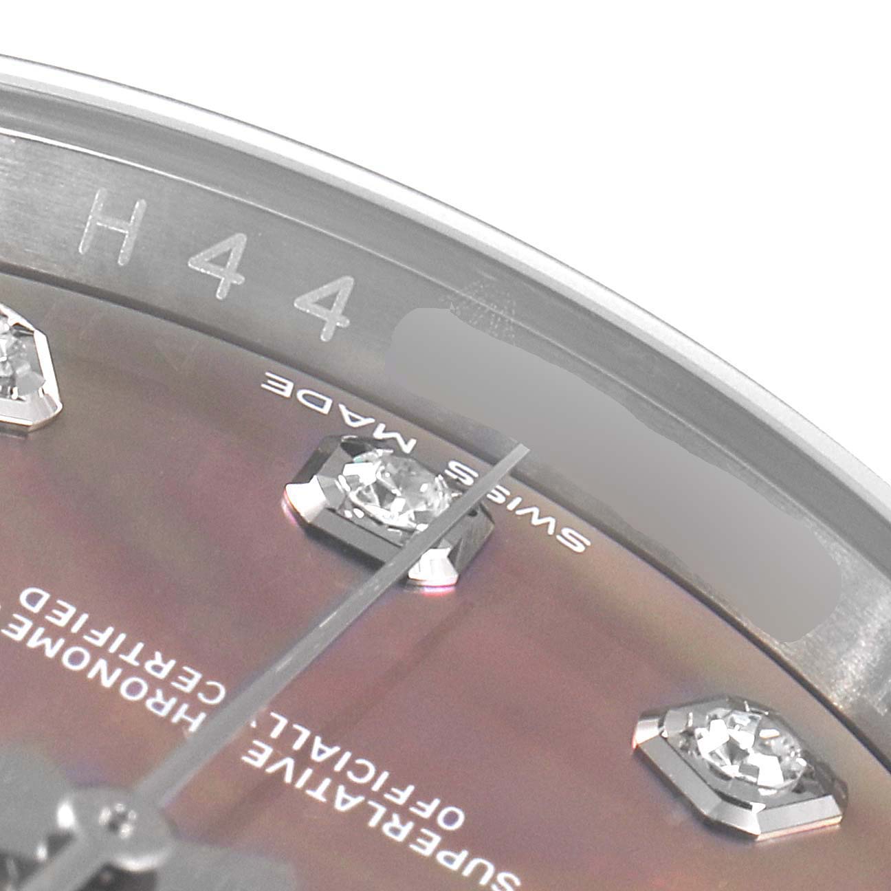 This close-up of a Rolex Datejust 116234 Men
s Stainless Steel Mother of Pearl Dial 116234 Men
s Stainless Steel Mother of Pearl Dial shows parts of the bezel, dial, and diamond-studded markers at an angle.