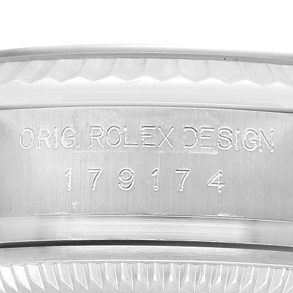 The image shows a close-up of the side of a Rolex Datejust 179174 Women's Stainless Steel Silver Dial, highlighting the engraved serial and reference numbers.