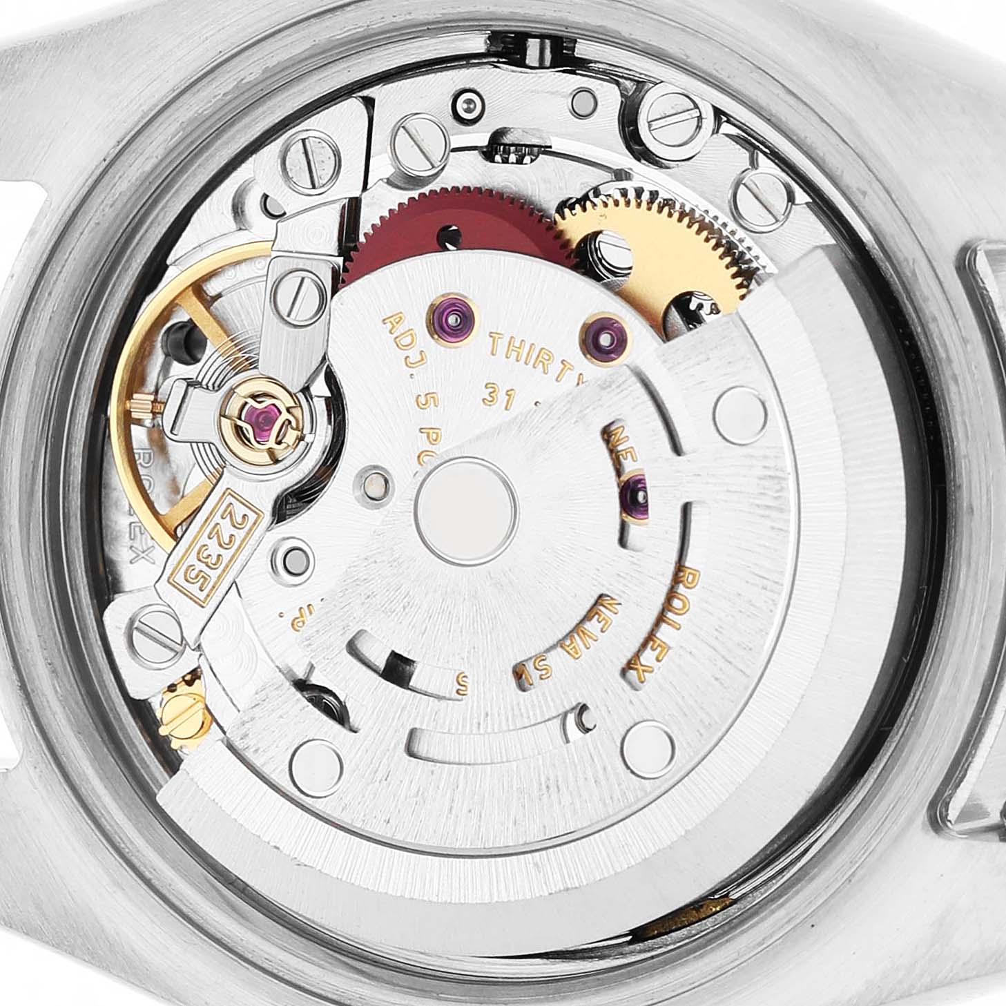 The image shows a close-up view of the movement inside a Rolex Datejust 179174 Women's Stainless Steel White Dial watch, highlighting gears and the rotor mechanism.