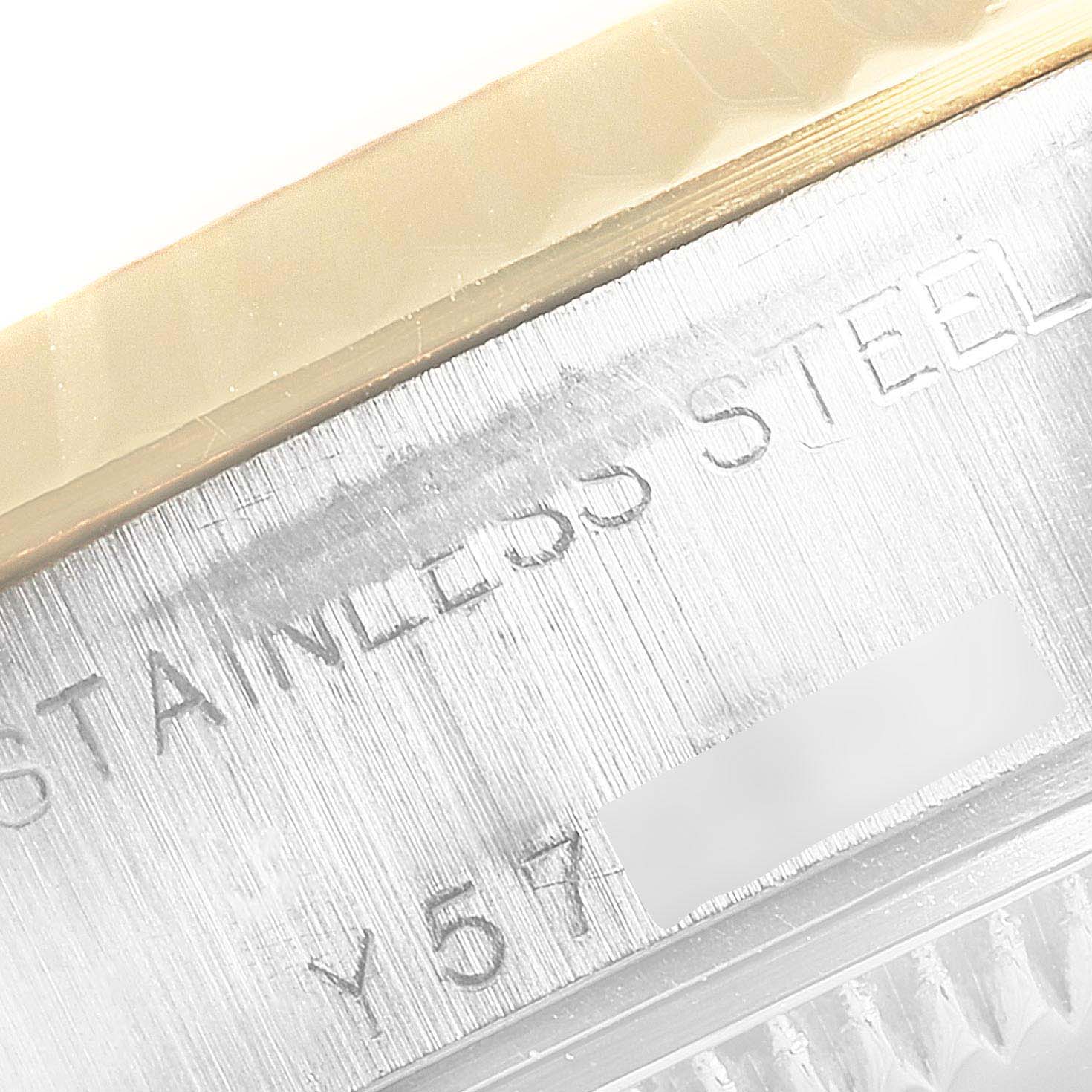 This close-up image of a Rolex Datejust 79173 Women's Steel and Gold (two tone) Black Dial 79173 Women's Steel and Gold (two tone) Black Dial watch shows the engraved "STAINLESS STEEL" text and partial serial number on the case.