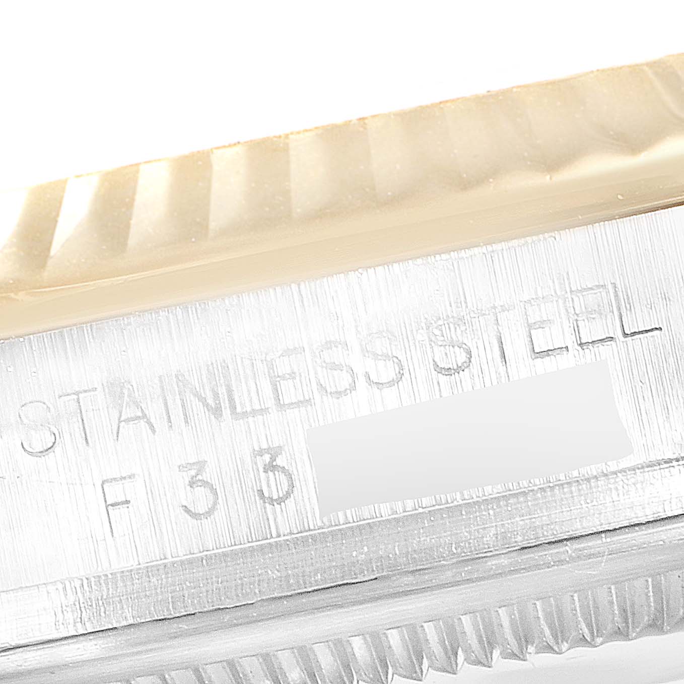 This close-up image shows the stainless steel engraving and fluted bezel of a Rolex Datejust 116233 Men
s Steel and Gold (two tone) Black Dial 116233 Men
s Steel and Gold (two tone) Black Dial watch.