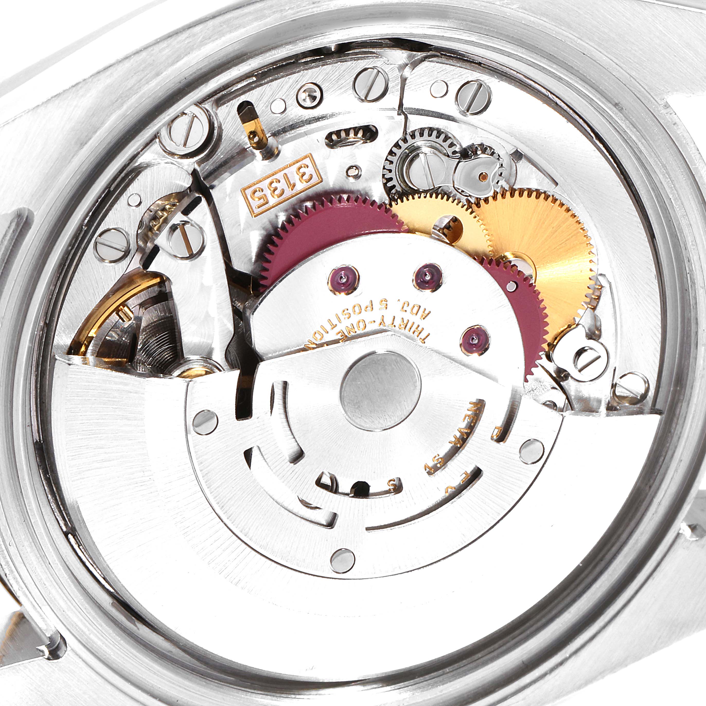 This image shows a close-up of the movement mechanism inside a Rolex Datejust 116233 Men
s Steel and Gold (two tone) Black Dial 116233 Men
s Steel and Gold (two tone) Black Dial watch, highlighting the gears and intricate components.