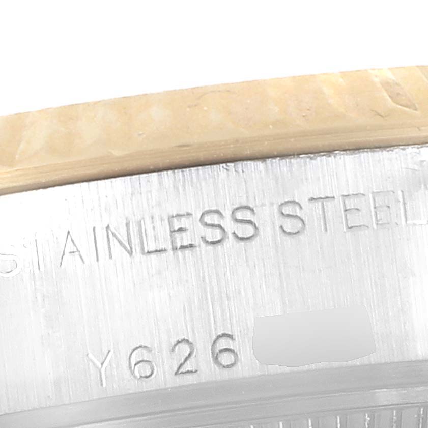 This close-up image of a Rolex Datejust 79173 Women's Steel and Gold (two tone) Champagne Dial 79173 Women's Steel and Gold (two tone) Champagne Dial watch shows the engraved text "STAINLESS STEEL" and a partial serial number.