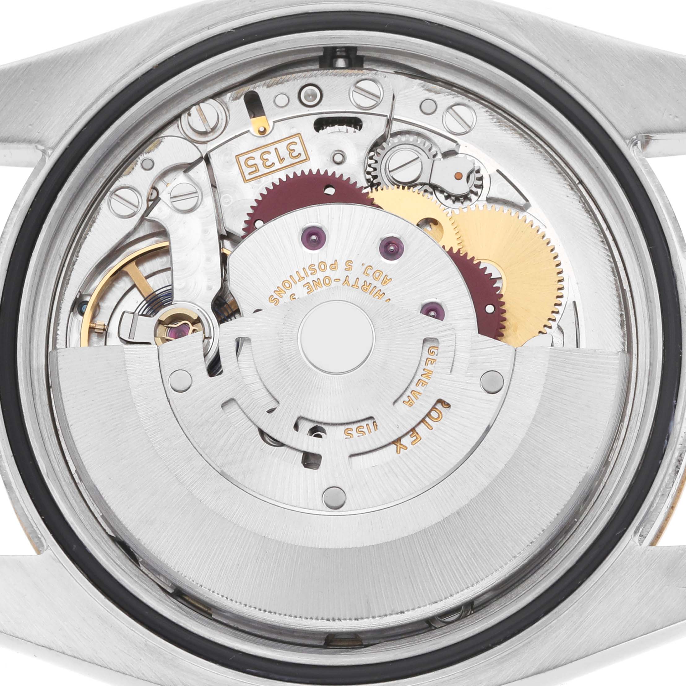 The image shows the internal movement of a Rolex Datejust 116233 Men
s Steel and Gold (two tone) Champagne Dial watch from a rear angle, highlighting intricate gears and components.