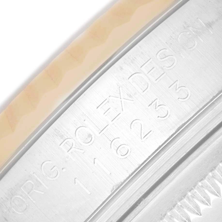 This image shows a close-up of the engraved edge on a Rolex Datejust 116233 Men
s Steel and Gold (two tone) Champagne Dial, highlighting the inscription details.