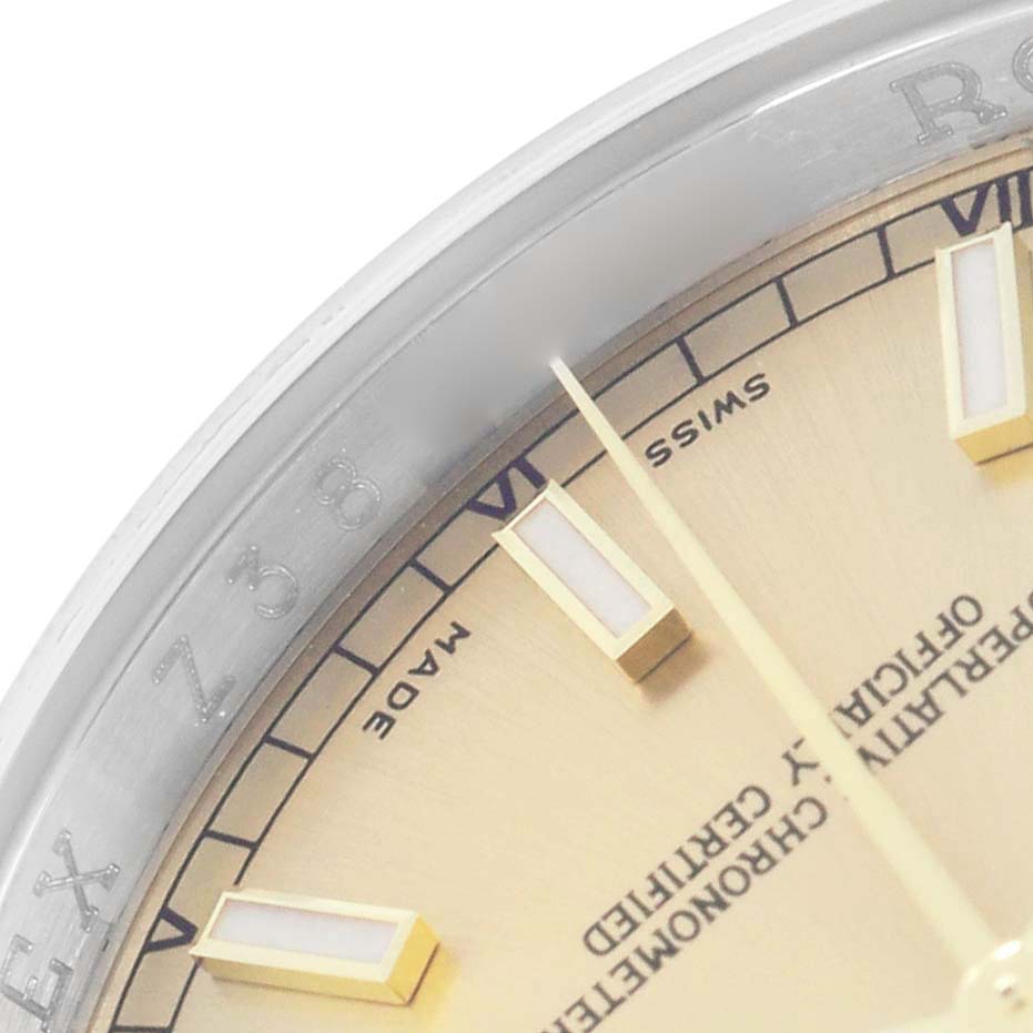 The image shows a close-up of the dial, hour markers, and bezel of a Rolex Datejust 116233 Men
s Steel and Gold (two tone) Champagne Dial model.