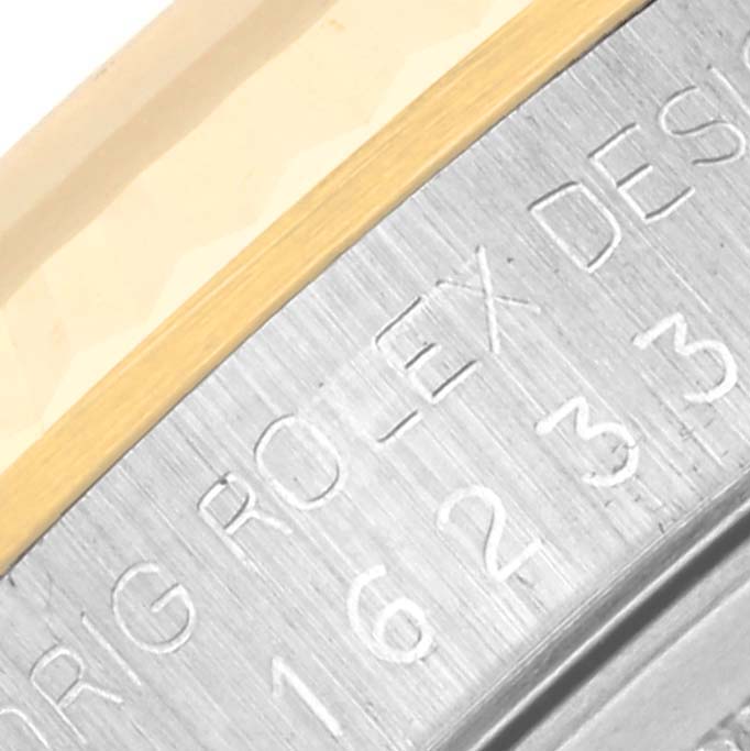 Close-up of the side detail showing "ROLEX" engraving on a two-tone bezel of the Rolex Datejust 16233 Men's Steel and Gold (two tone) Silver Dial 16233 Men's Steel and Gold (two tone) Silver Dial model.