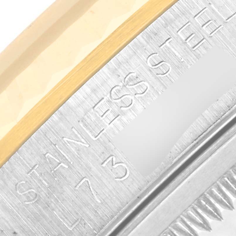 Close-up of the case and bezel of a Rolex Datejust 16233 Men's Steel and Gold (two tone) Silver Dial 16233 Men's Steel and Gold (two tone) Silver Dial, showing "STAINLESS STEEL" engraving.