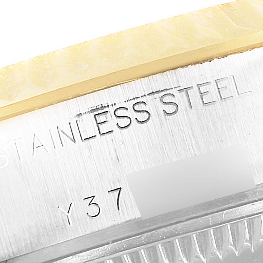 This close-up image shows the side engraving detailing the stainless steel material and part of the serial number on a Rolex Datejust 79173 Women
s Stainless Steel Silver Dial 79173 Women
s Stainless Steel Silver Dial watch.