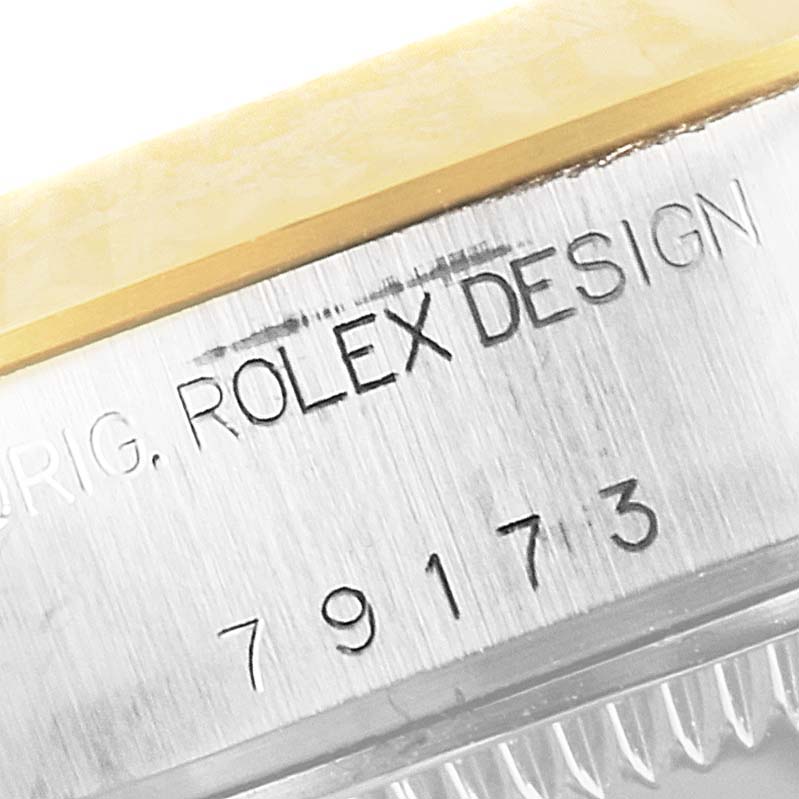 The image shows a close-up of the side of a Rolex Datejust 79173 Women
s Stainless Steel Silver Dial 79173 Women
s Stainless Steel Silver Dial watch, highlighting the model number and "Rolex Design" engraving.