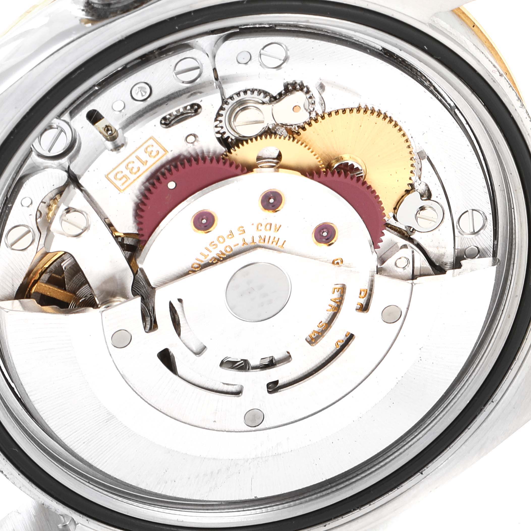 This image shows an interior view of the Rolex Turn-o-Graph 116263 Men's Steel and Gold (two tone) White Dial 116263 Men's Steel and Gold (two tone) White Dial watch, highlighting its intricate mechanical movement parts.