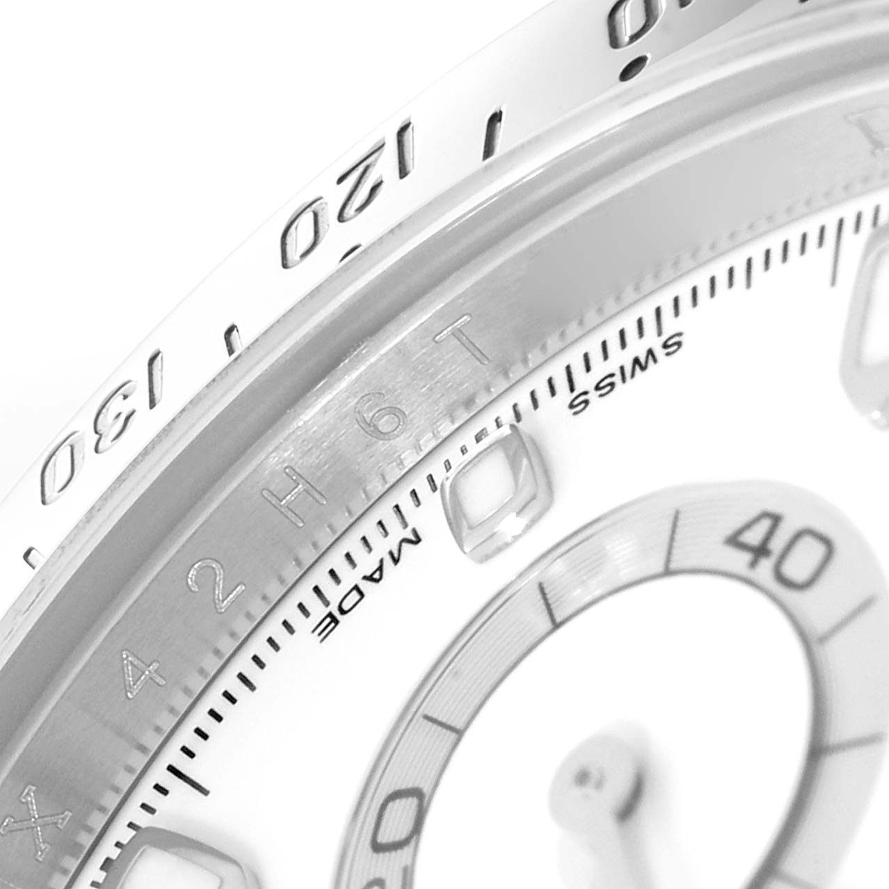This close-up image shows the bezel and part of the dial of a Rolex Daytona 116520 Men's Stainless Steel White Dial 116520 Men's Stainless Steel White Dial watch.