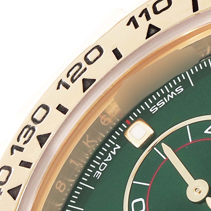 The image shows a close-up of the bezel and part of the dial of a Rolex Daytona 116508 Men's Yellow Gold Green Dial 116508 Men's Yellow Gold Green Dial watch.