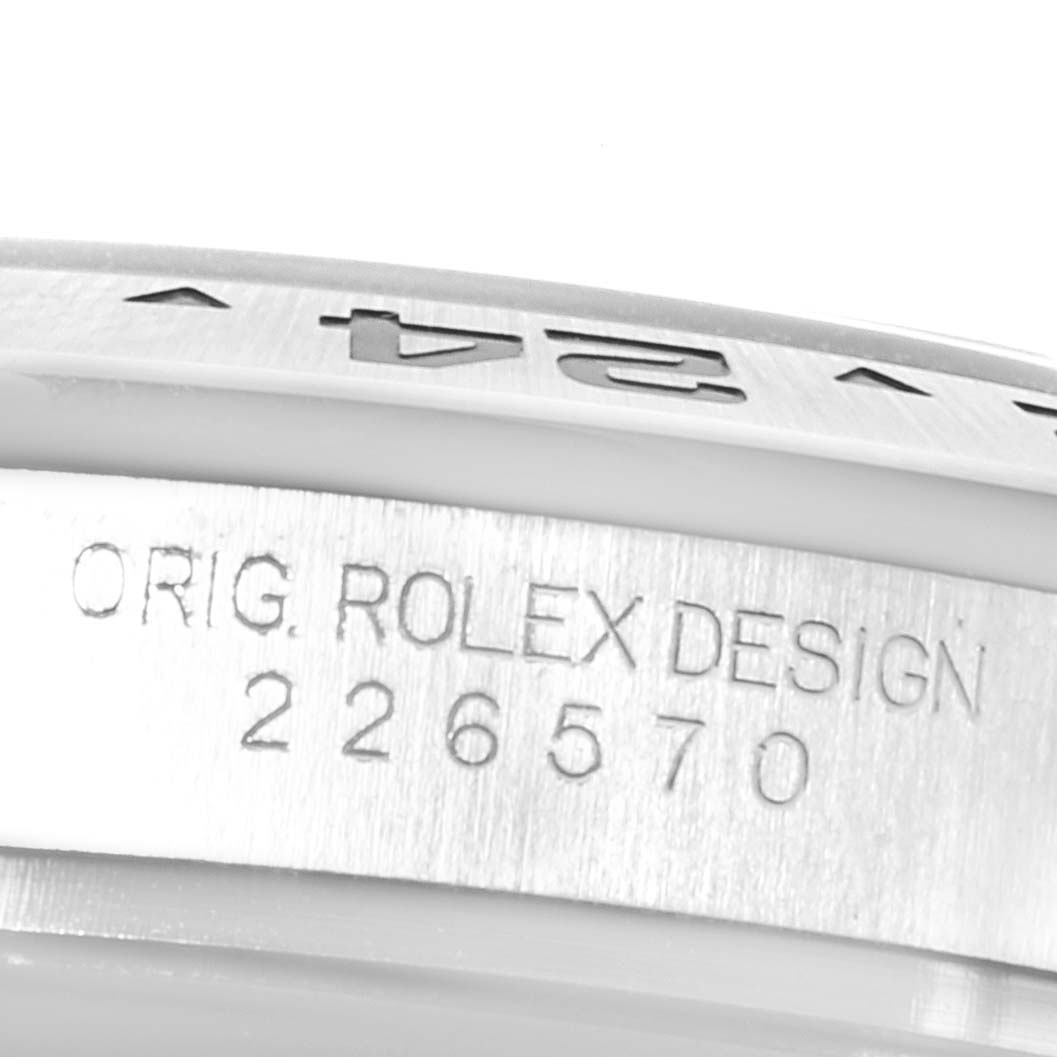 The image shows a close-up of the engraved serial number and "ORIG. ROLEX DESIGN" marking on the bezel of a Rolex Explorer 226570 Men's Stainless Steel Black Dial 226570 Men's Stainless Steel Black Dial watch.
