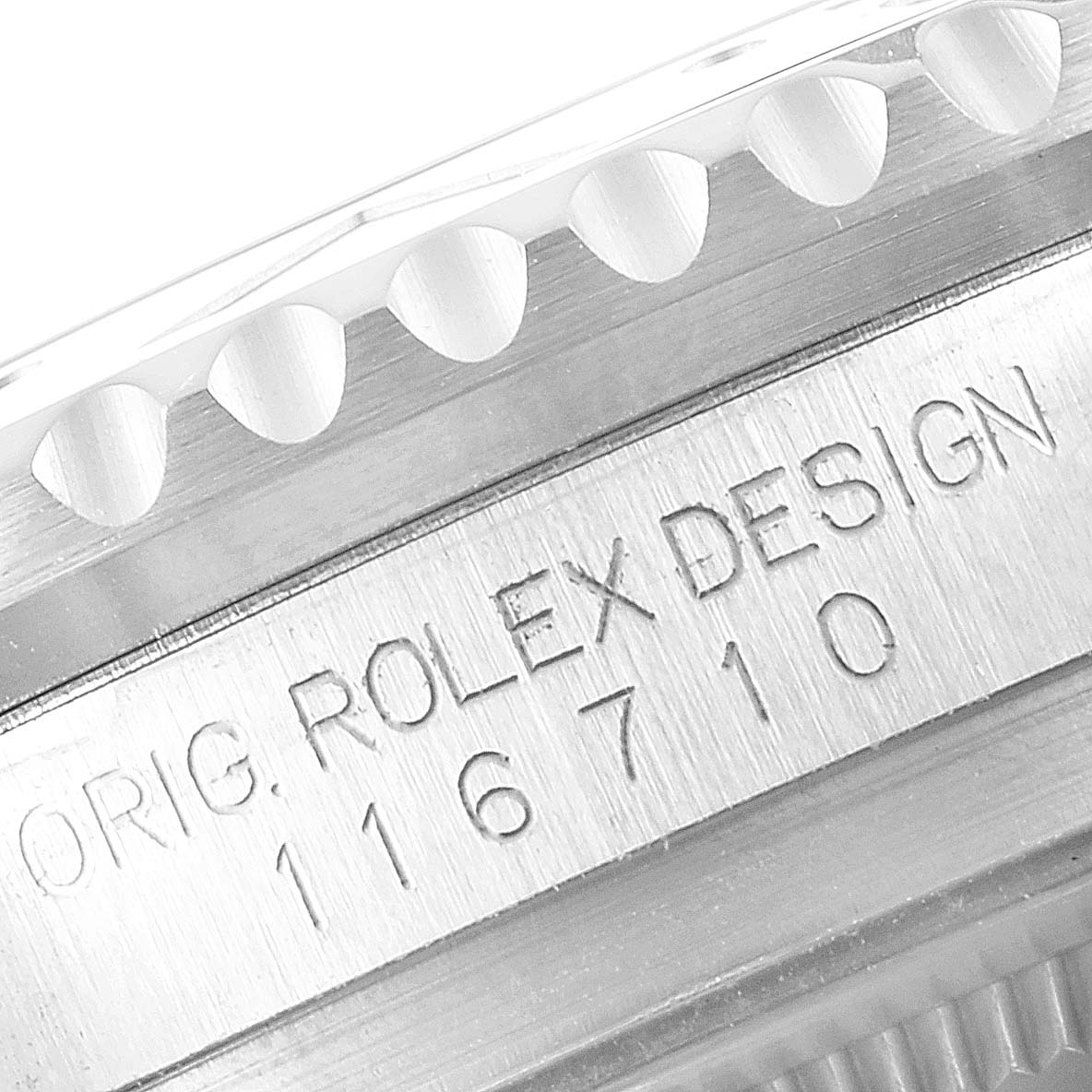 The image shows a close-up of the case edge and serial number engraving of a Rolex GMT-Master 116710 Men's Stainless Steel Black Dial 116710 Men's Stainless Steel Black Dial model.