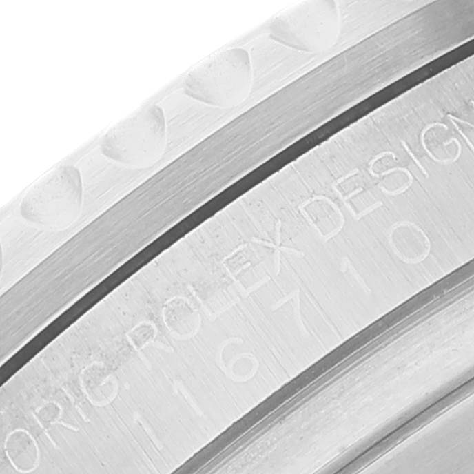 This close-up angle of the Rolex GMT-Master 116710 Men's Stainless Steel Black Dial 116710 Men's Stainless Steel Black Dial watch displays part of the bezel and engraved model details.