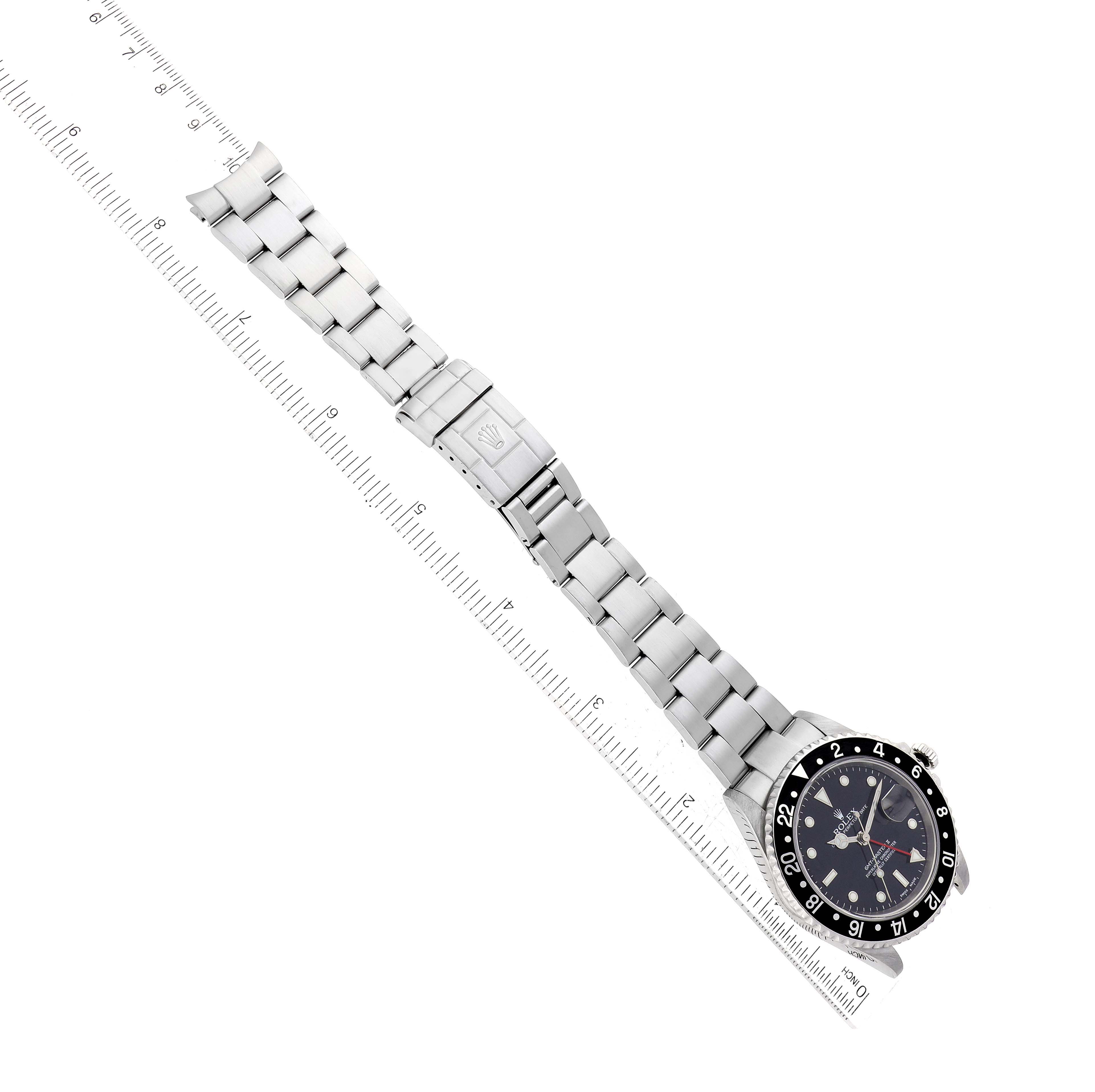 The image shows a Rolex GMT-Master 16710 Men's Stainless Steel Black Dial 16710 Men's Stainless Steel Black Dial watch laid flat with the watch face and stainless steel bracelet fully visible.