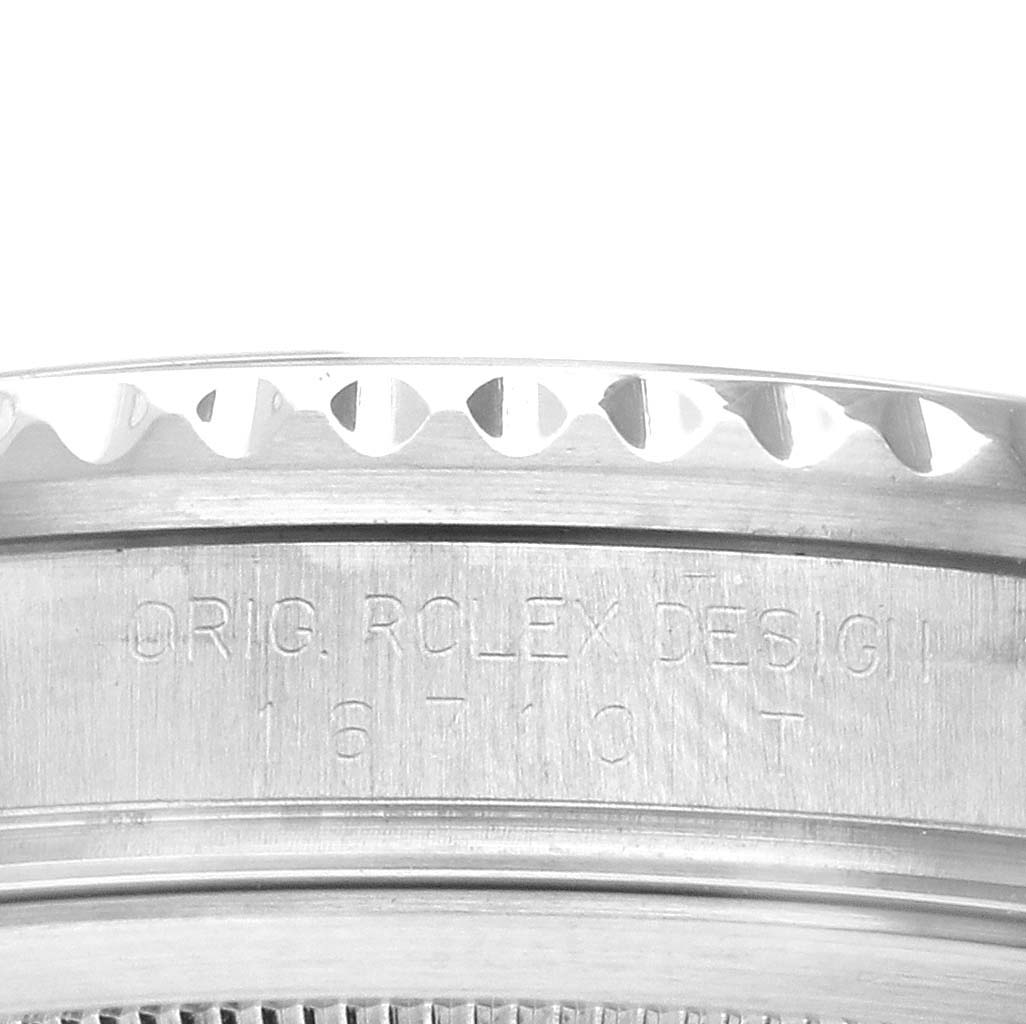 This image shows the engraved side of the bezel and case of a Rolex GMT-Master 16710 Men's Stainless Steel Black Dial 16710 Men's Stainless Steel Black Dial watch.