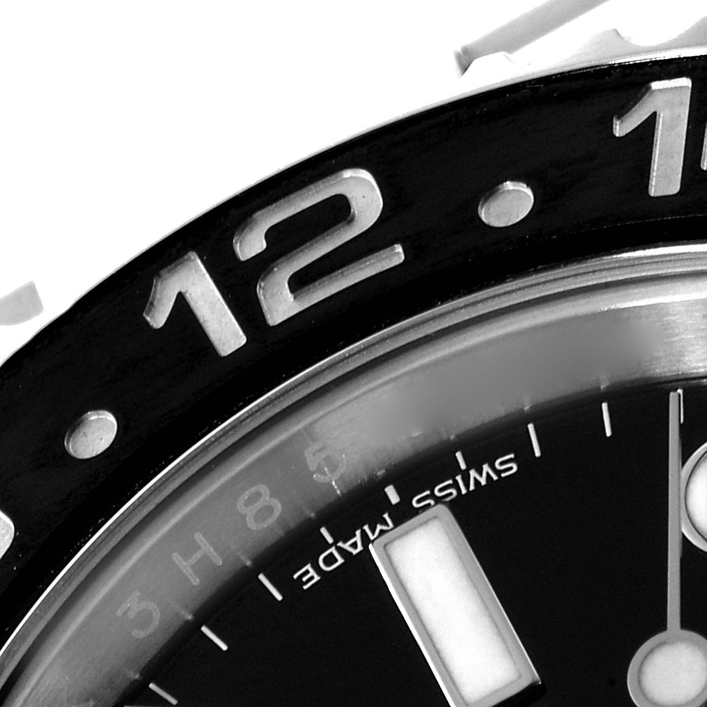 This close-up shows the bezel and part of the dial of a Rolex GMT-Master 116710 Men's Stainless Steel Black Dial 116710 Men's Stainless Steel Black Dial, focusing on the "12" marker.