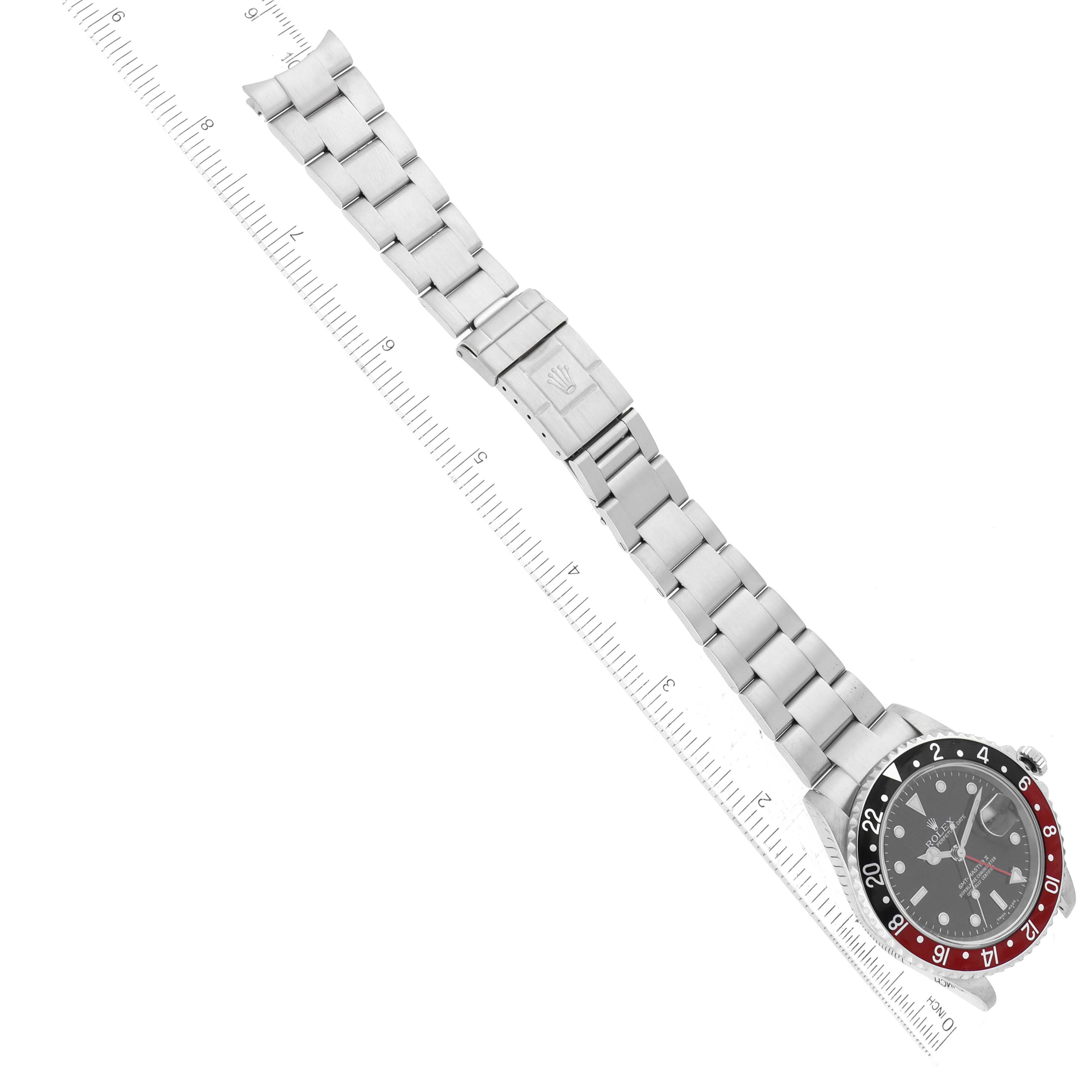 The image shows a top-down view of a Rolex GMT-Master 16710 Men's Stainless Steel Black Dial 16710 Men's Stainless Steel Black Dial watch, including the entire bracelet and clasp with a ruler beside it.