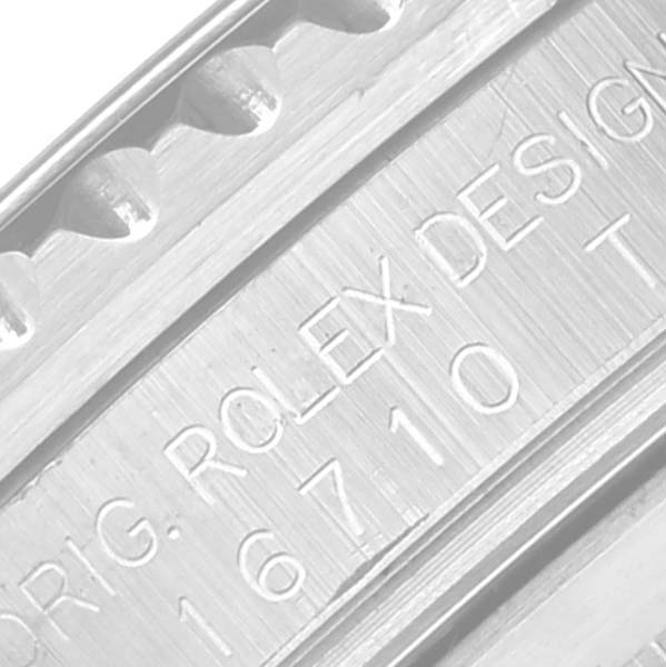 The image shows a close-up shot of the Rolex GMT-Master 16710 Men's Stainless Steel Black Dial 16710 Men's Stainless Steel Black Dial model's engraved watch case, highlighting the branding and model number.