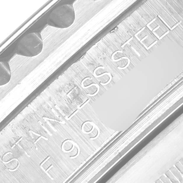 This close-up image shows the side of a Rolex GMT-Master 16710 Men's Stainless Steel Black Dial 16710 Men's Stainless Steel Black Dial watch case, revealing the "STAINLESS STEEL" engraving.