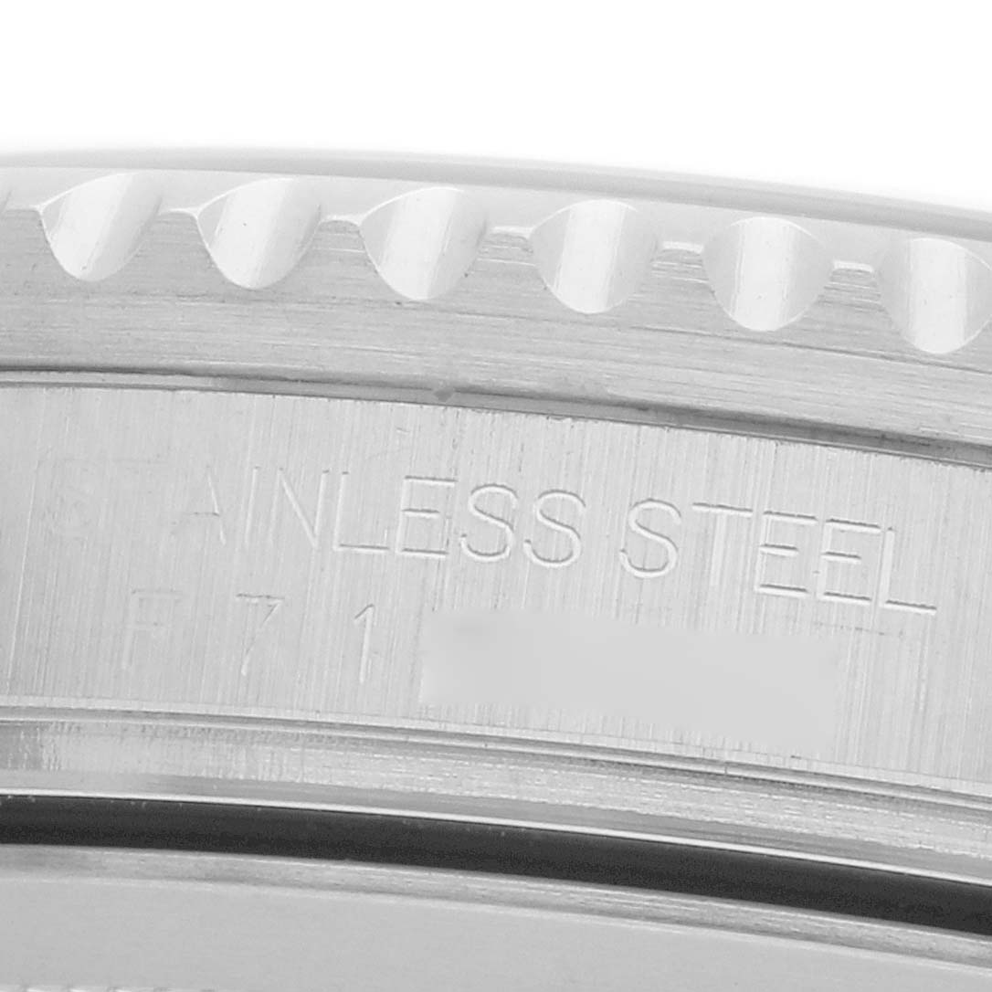The image shows a close-up of the side of a Rolex GMT-Master 16710 Men
s Stainless Steel Black Dial watch, highlighting the stainless steel engraving.