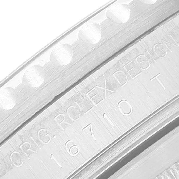 This is a close-up of the branding and reference number 16710 T on the Rolex GMT-Master 16710 Men
s Stainless Steel Black Dial 16710 Men
s Stainless Steel Black Dial bezel.