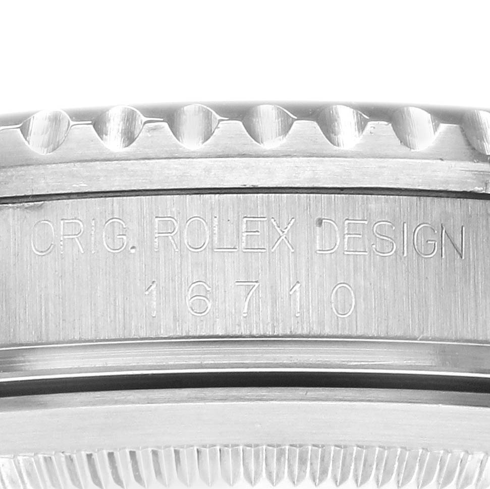 This image shows a close-up of the engraved side of a Rolex GMT-Master 16710 Men's Stainless Steel Black Dial 16710 Men's Stainless Steel Black Dial 16710 watch's case.