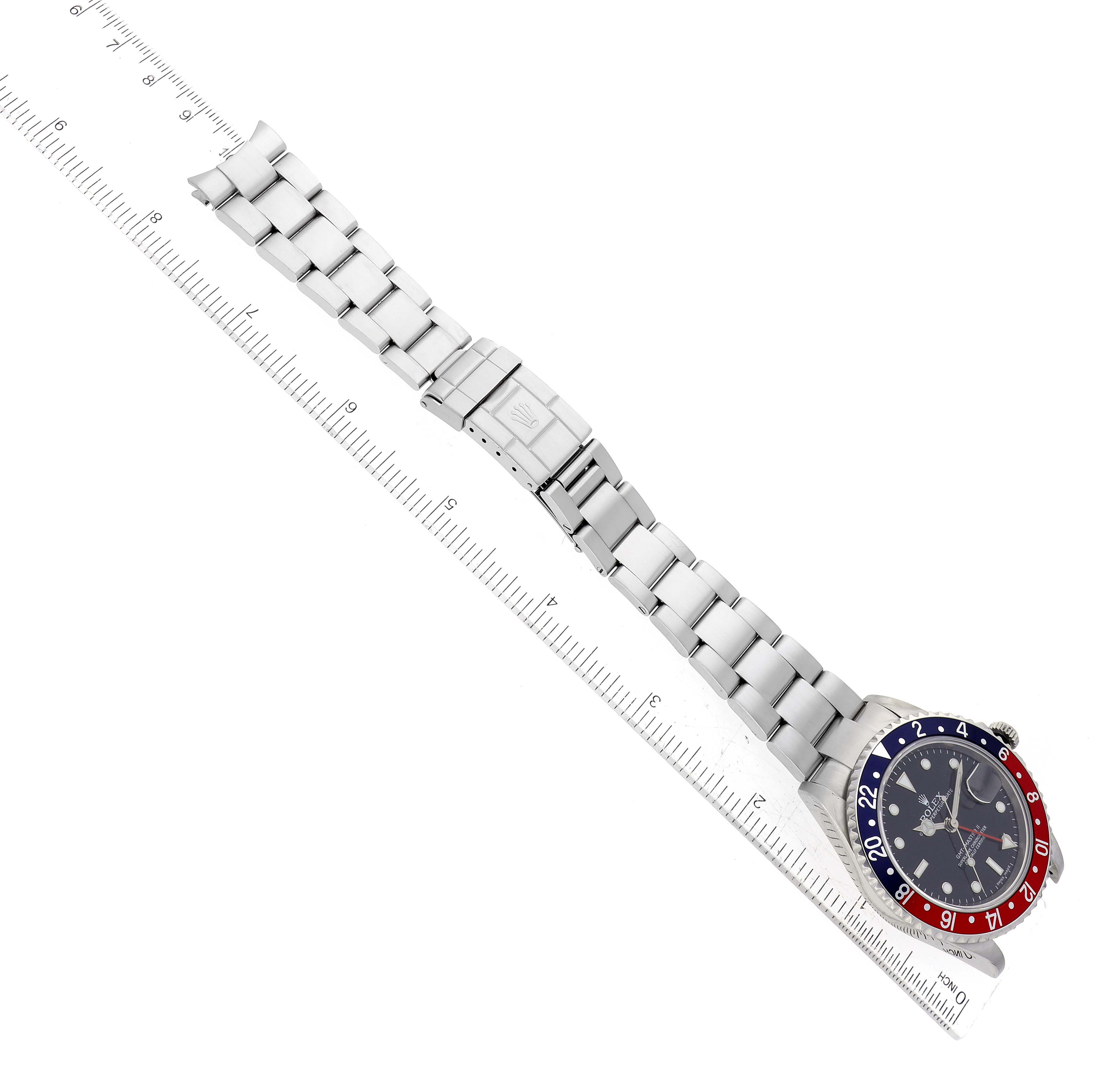 This image shows the full length of a Rolex GMT-Master 16710 Men's Stainless Steel Black Dial 16710 Men's Stainless Steel Black Dial watch laid flat, with a focus on its bracelet and bezel.