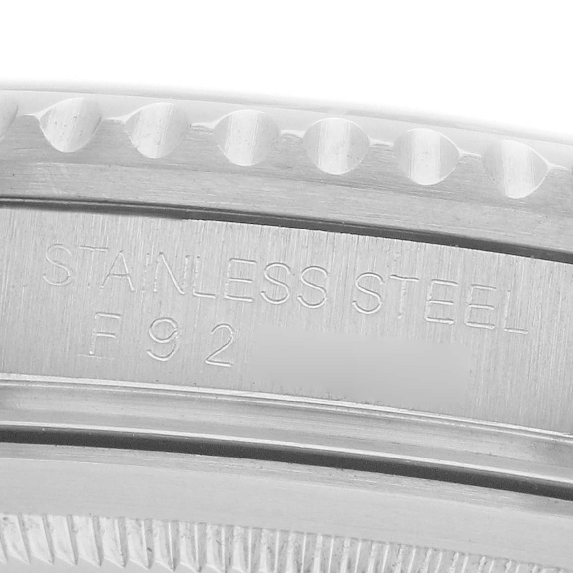 The image shows a close-up of the Rolex GMT-Master 16710 Men
s Stainless Steel Black Dial
s stainless steel case with engraved details.