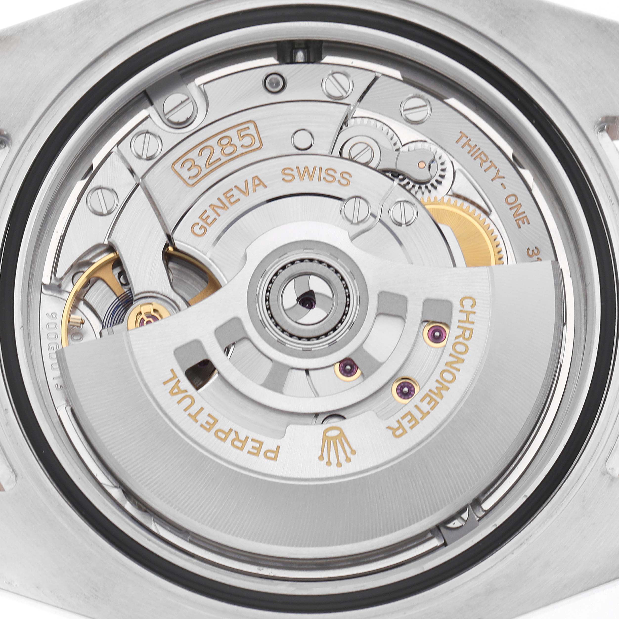 The image shows the movement of a Rolex GMT-Master 126711 Men
s Steel and Gold (two tone) Black Dial, focusing on the intricate internal parts and the rotor.