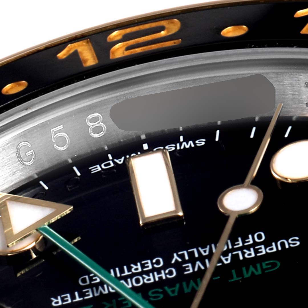 This close-up image of a Rolex GMT-Master 116713 Men
s Stainless Steel Black Dial 116713 Men
s Stainless Steel Black Dial watch shows the dial, hands, bezel, and part of the rehaut with engravings.