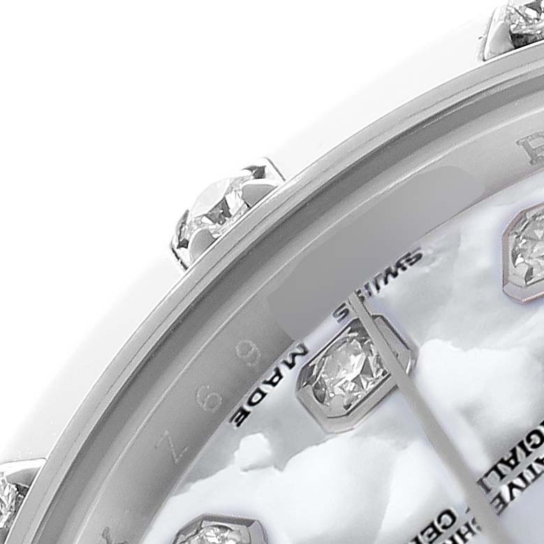 The image shows a close-up of the Rolex Pearlmaster 80319 Women
s White Gold Mother of Pearl Dial
s bezel and dial, highlighting the gemstone hour markers and part of the face.