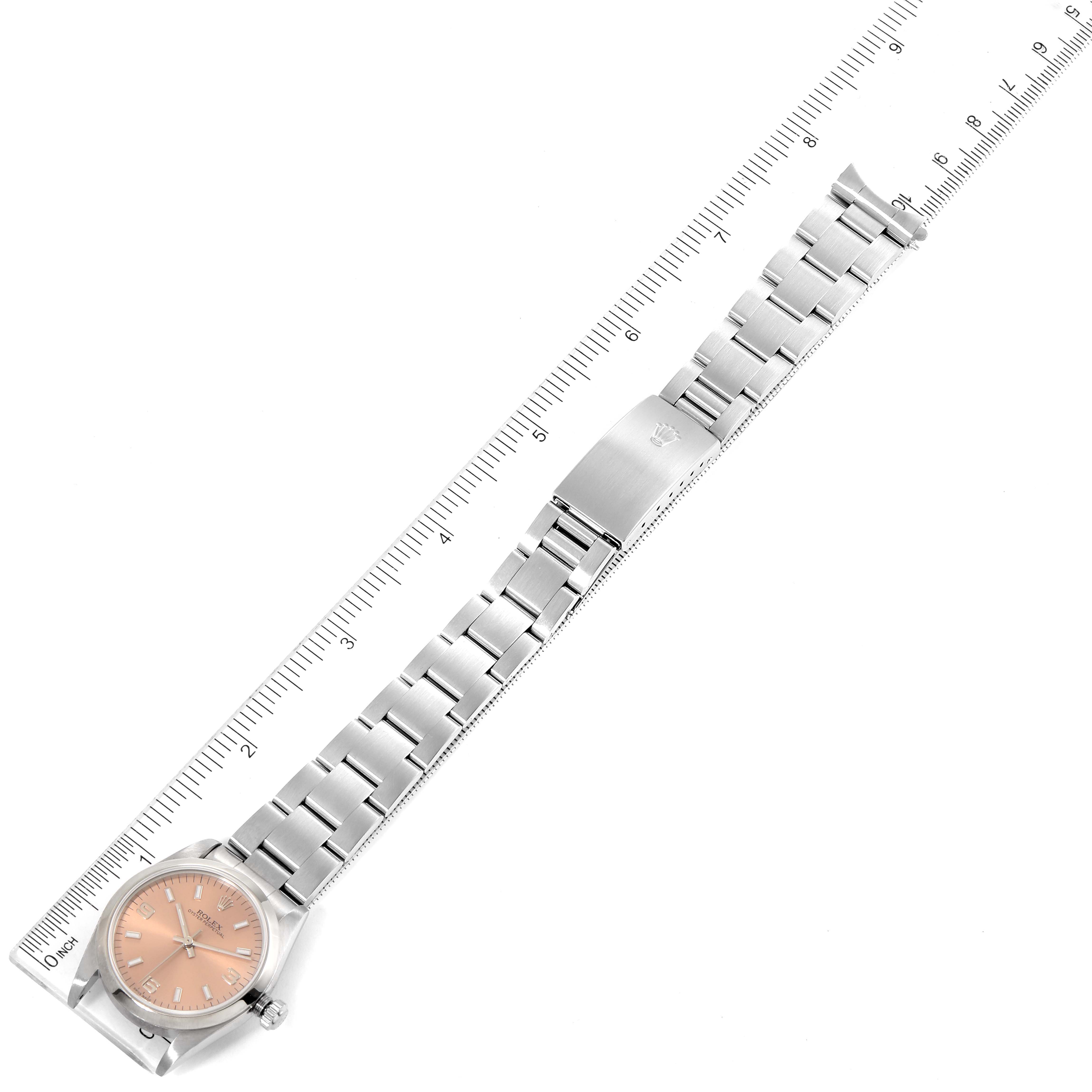 The image shows a top-down view of a Rolex Mid-Size 77080 Women's Stainless Steel Pink Dial 77080 Women's Stainless Steel Pink Dial watch displaying the full length of the bracelet and the face of the watch.