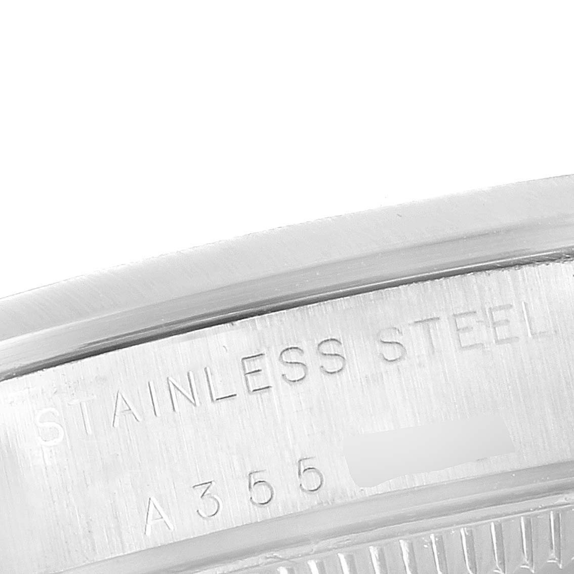 This image shows a close-up of the bezel edge and engraved model information of the Mid-Size Rolex watch, made of stainless steel.