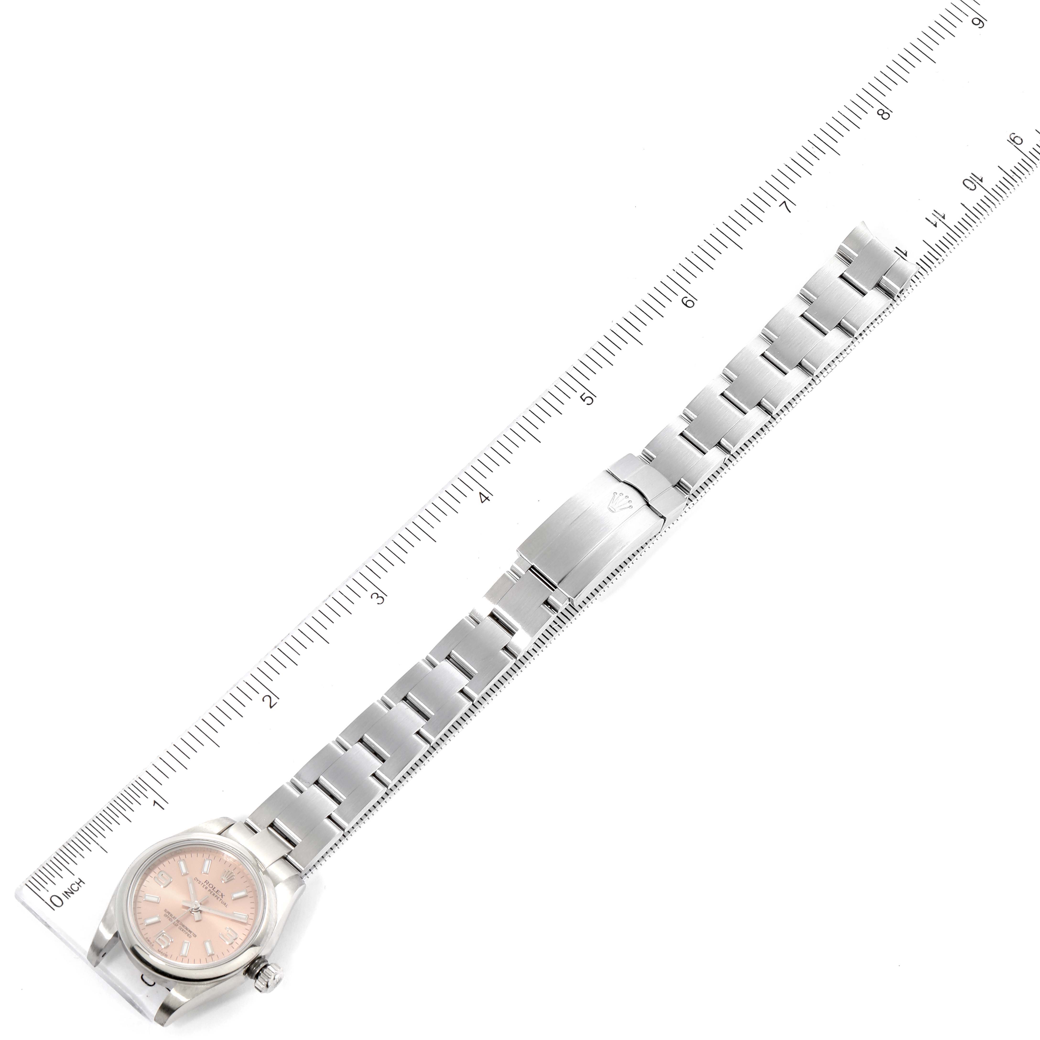 The image shows a Rolex Oyster Perpetual 176200 Women
s Stainless Steel Pink Dial 176200 Women
s Stainless Steel Pink Dial watch laid flat with its metal bracelet extended and a ruler beside it for scale.