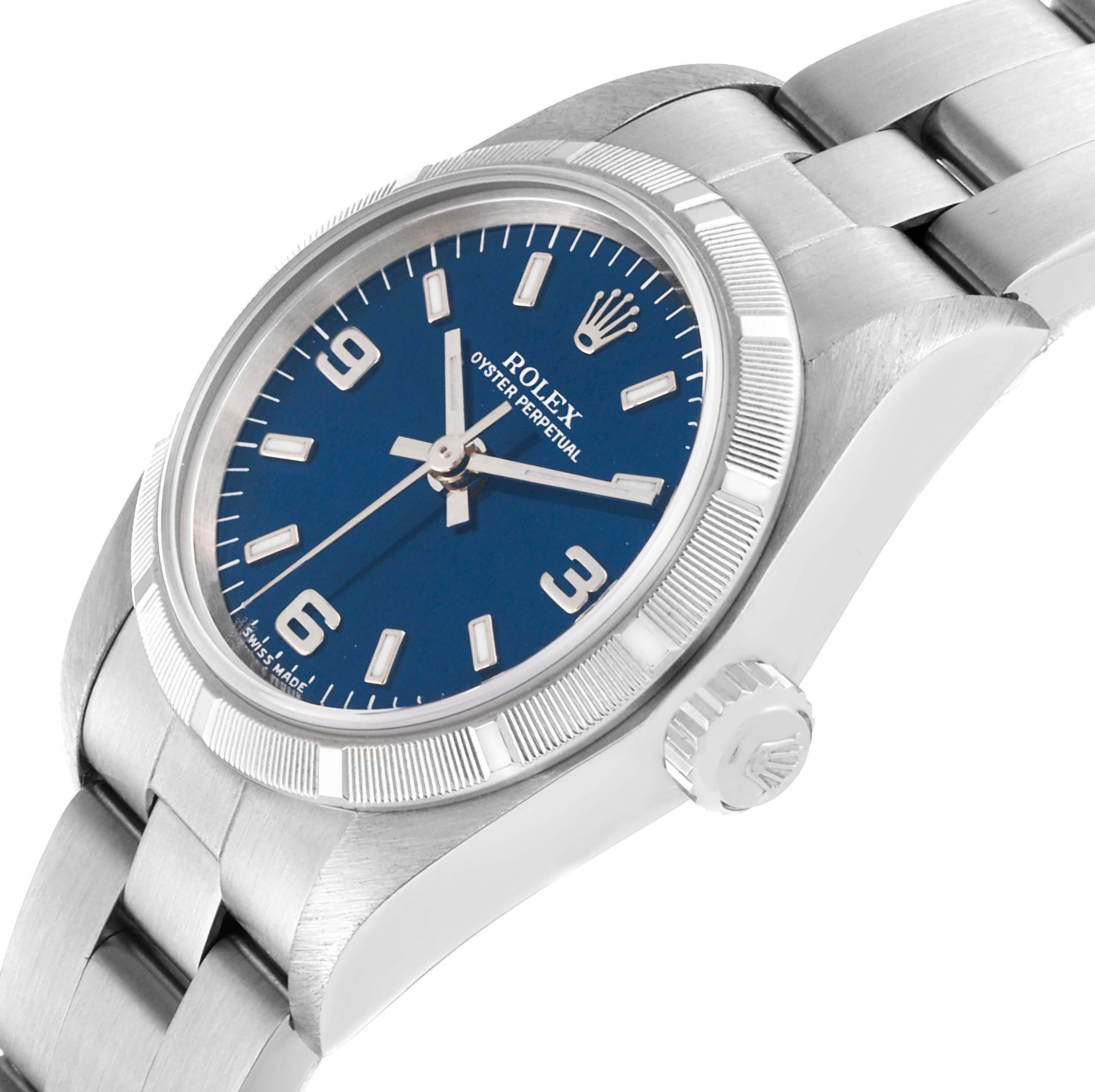 The image shows a Rolex Oyster Perpetual 76030 Women's Stainless Steel Blue Dial 76030 Women's Stainless Steel Blue Dial watch at an angle, highlighting its blue dial, crown, bezel, and metal bracelet.