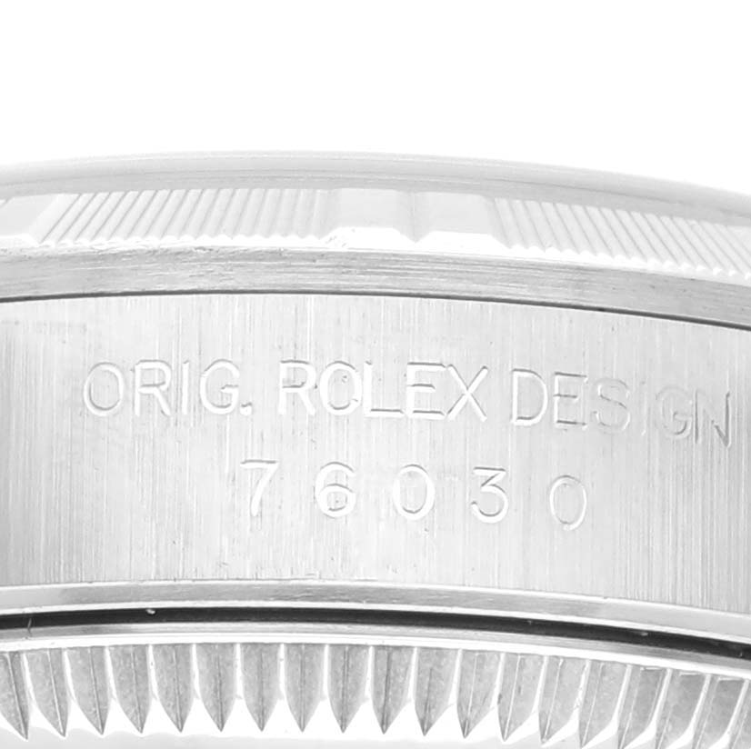 This image shows the side view of a Rolex Oyster Perpetual 76030 Women's Stainless Steel Blue Dial 76030 Women's Stainless Steel Blue Dial watch, displaying the model number and bezel.