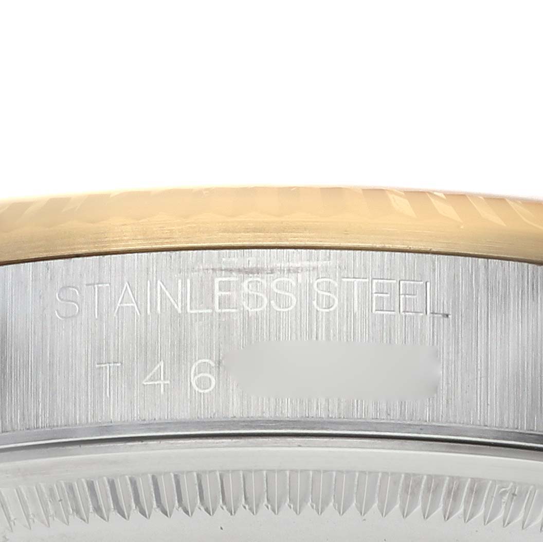 This image shows a close-up of the stainless steel bezel of a Rolex Oyster Perpetual 14233 Men's Steel and Gold (two tone) Silver Dial 14233 Men's Steel and Gold (two tone) Silver Dial watch.