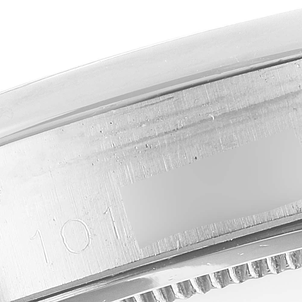 The image shows a close-up of the serial number engraved on the case of a Rolex Date 6694 Men's Stainless Steel Black Dial 6694 Men's Stainless Steel Black Dial model watch.