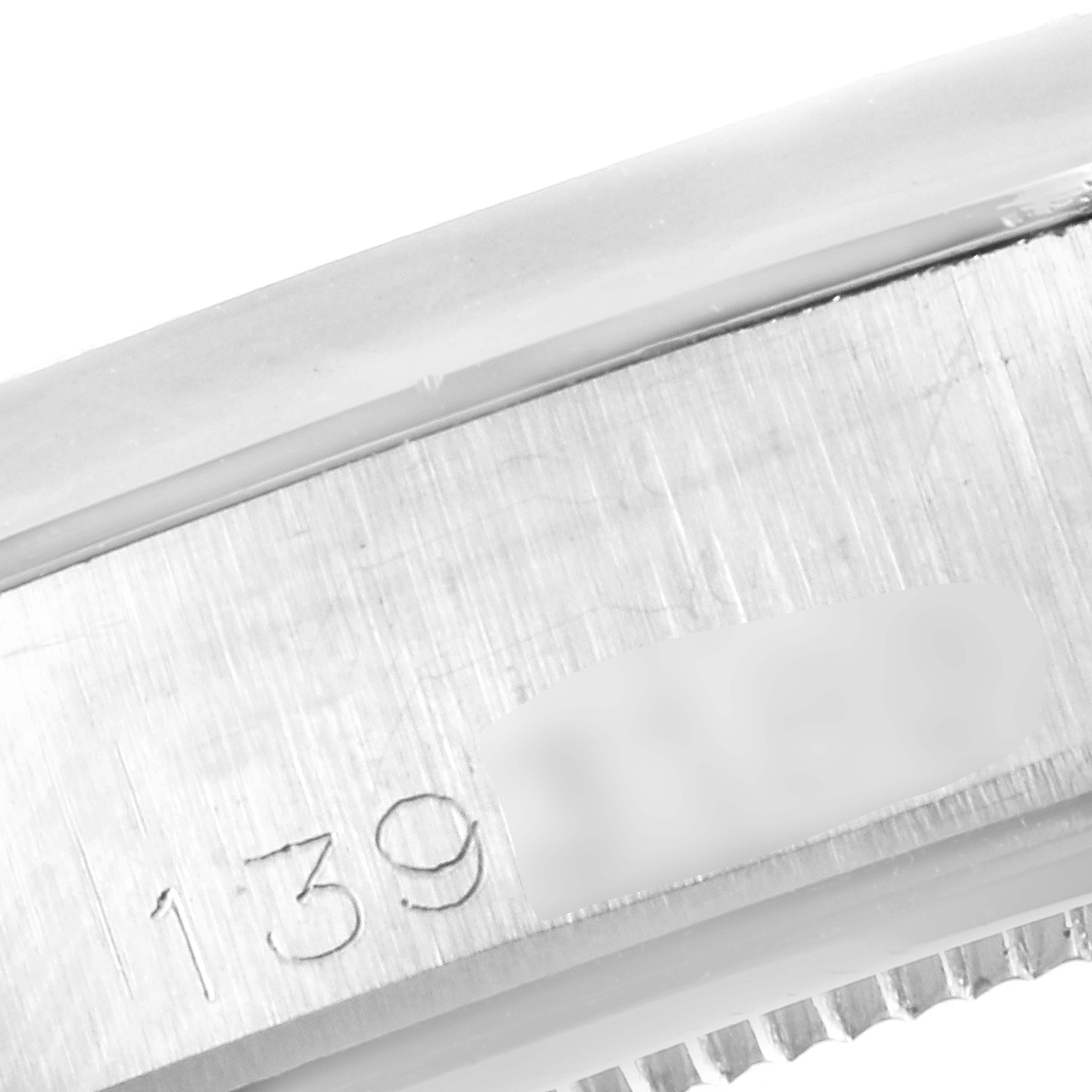 This image shows a close-up of the engraved serial number on the side of a Vintage Collection model by Rolex.
