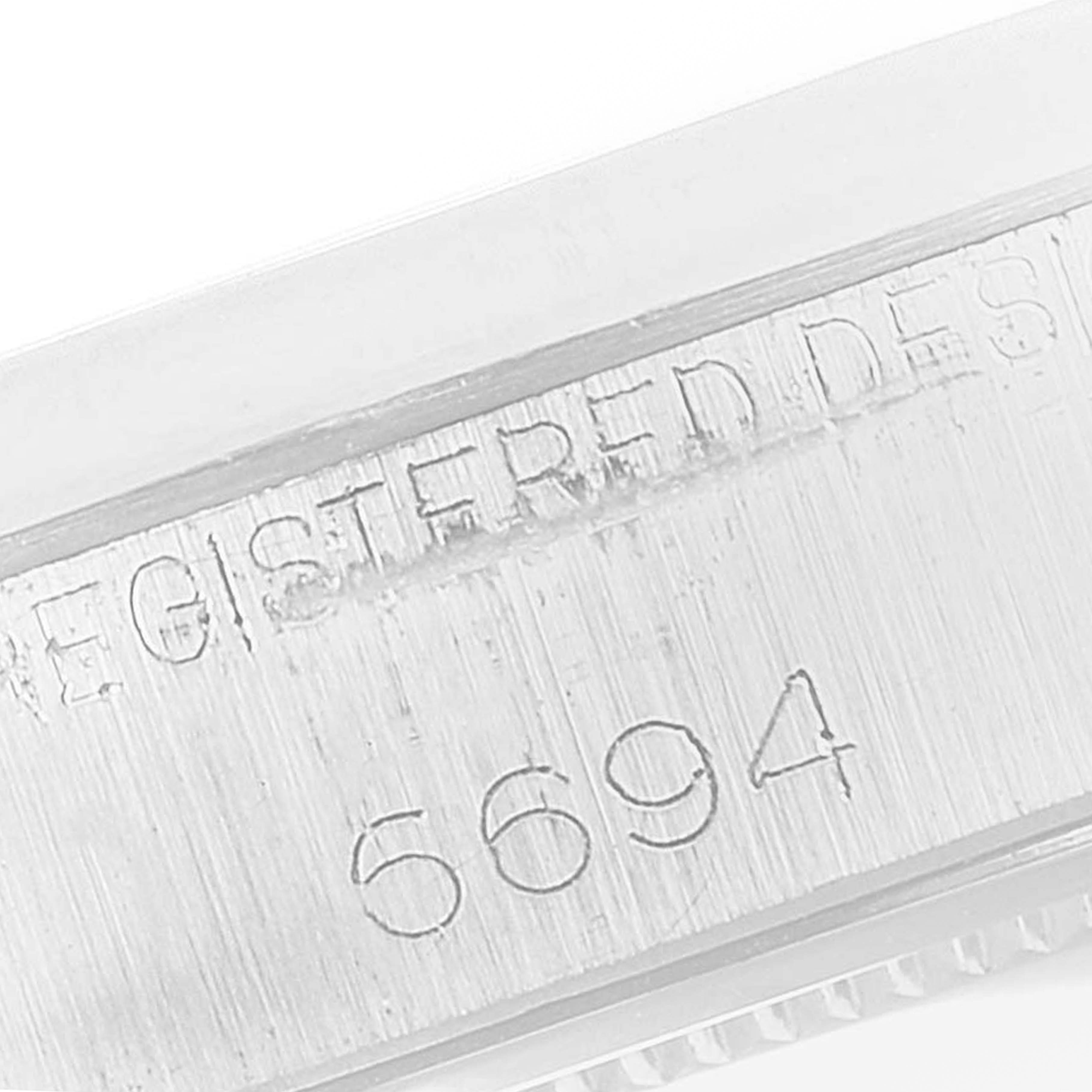 The image shows a close-up view of the model number "6694" engraved on a Rolex Vintage Collection 6694 Men's Stainless Steel Silver Dial 6694 Men's Stainless Steel Silver Dial watch case.