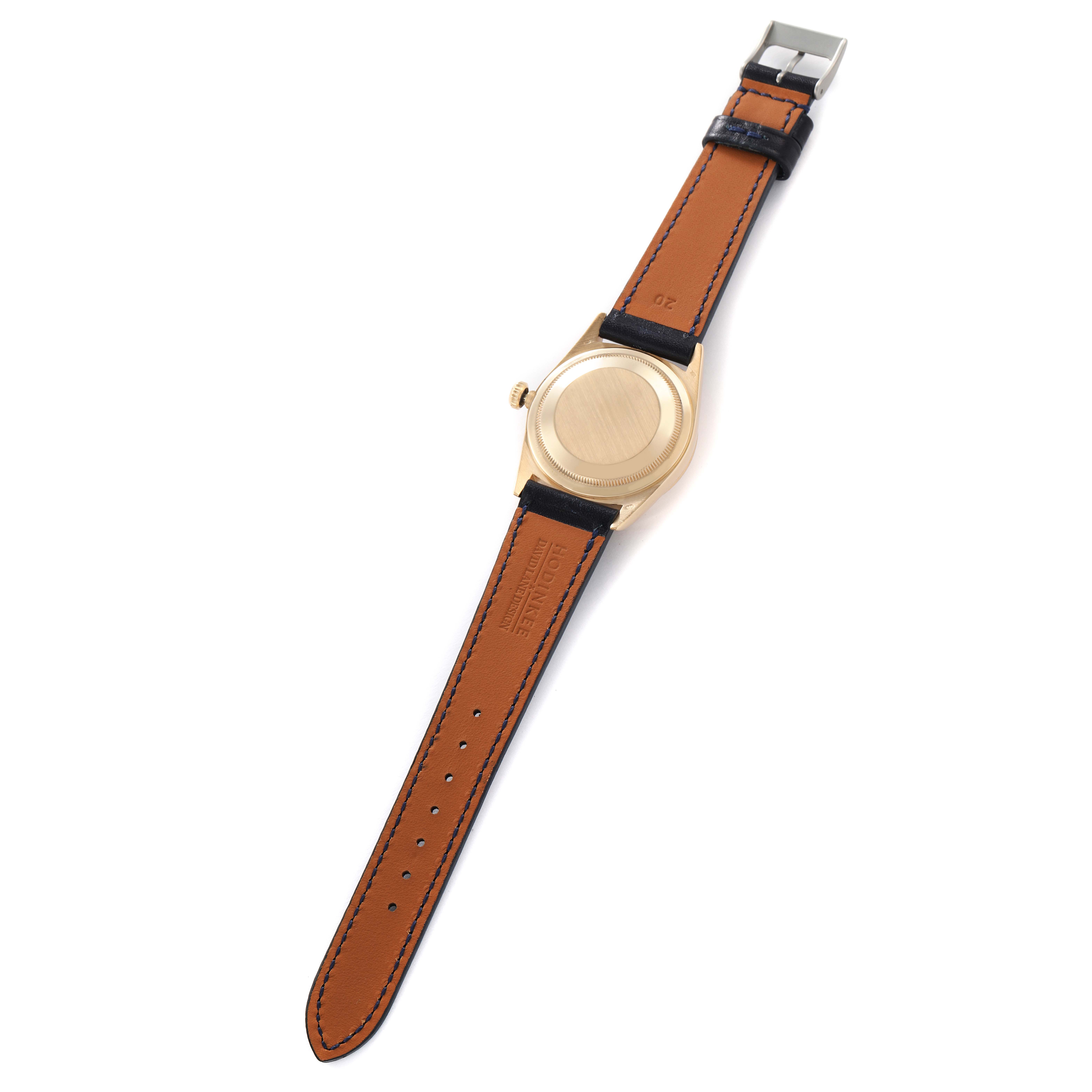 The Rolex President 18238 Men
s Yellow Gold Champagne Dial watch is shown from the back, displaying the leather strap and case back.