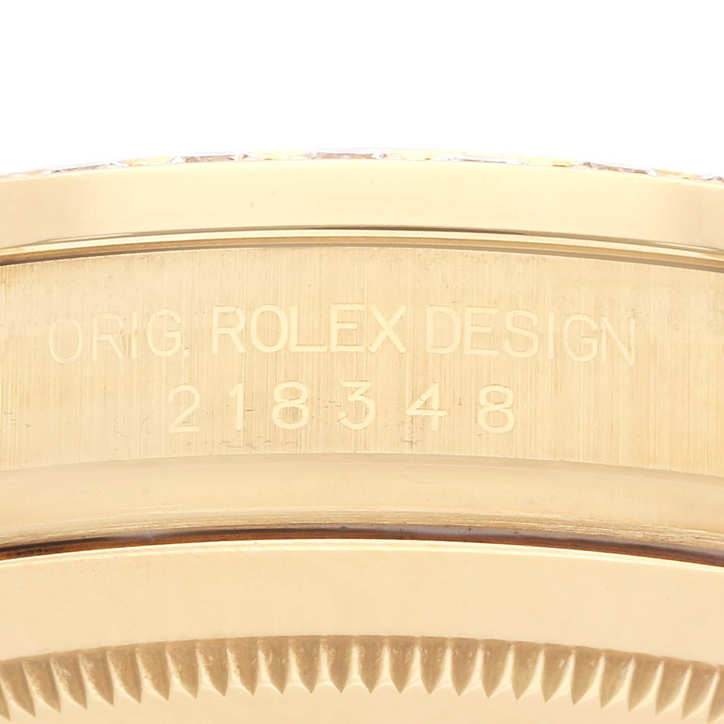 The image shows the engraved side of the Rolex President 218348 Men
s Yellow Gold Champagne Dial model, focusing on the design number.