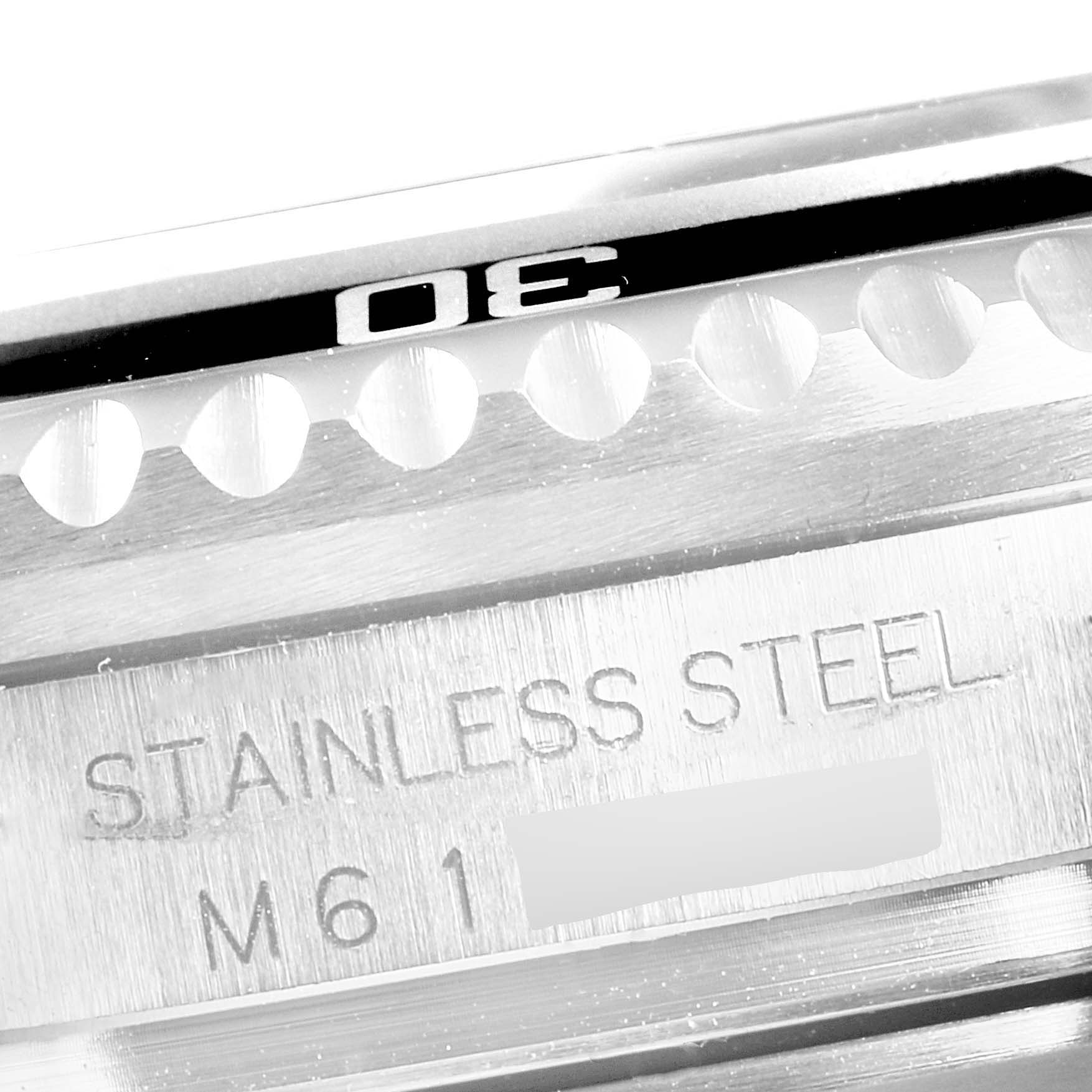 The image shows a close-up of the stainless steel bezel and case of a Rolex Sea-Dweller 16600 Men
s Stainless Steel Black Dial 16600 Men
s Stainless Steel Black Dial watch, highlighting the "STAINLESS STEEL" engraving.