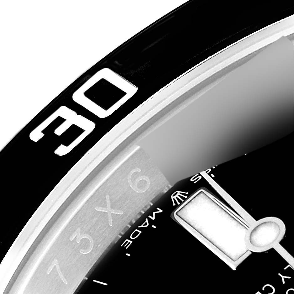 The image shows a close-up of the bezel and dial of a Rolex Submariner 126610 Men
s Stainless Steel Black Dial 126610 Men
s Stainless Steel Black Dial watch, focusing on the 30-minute mark and a portion of the hour hand.