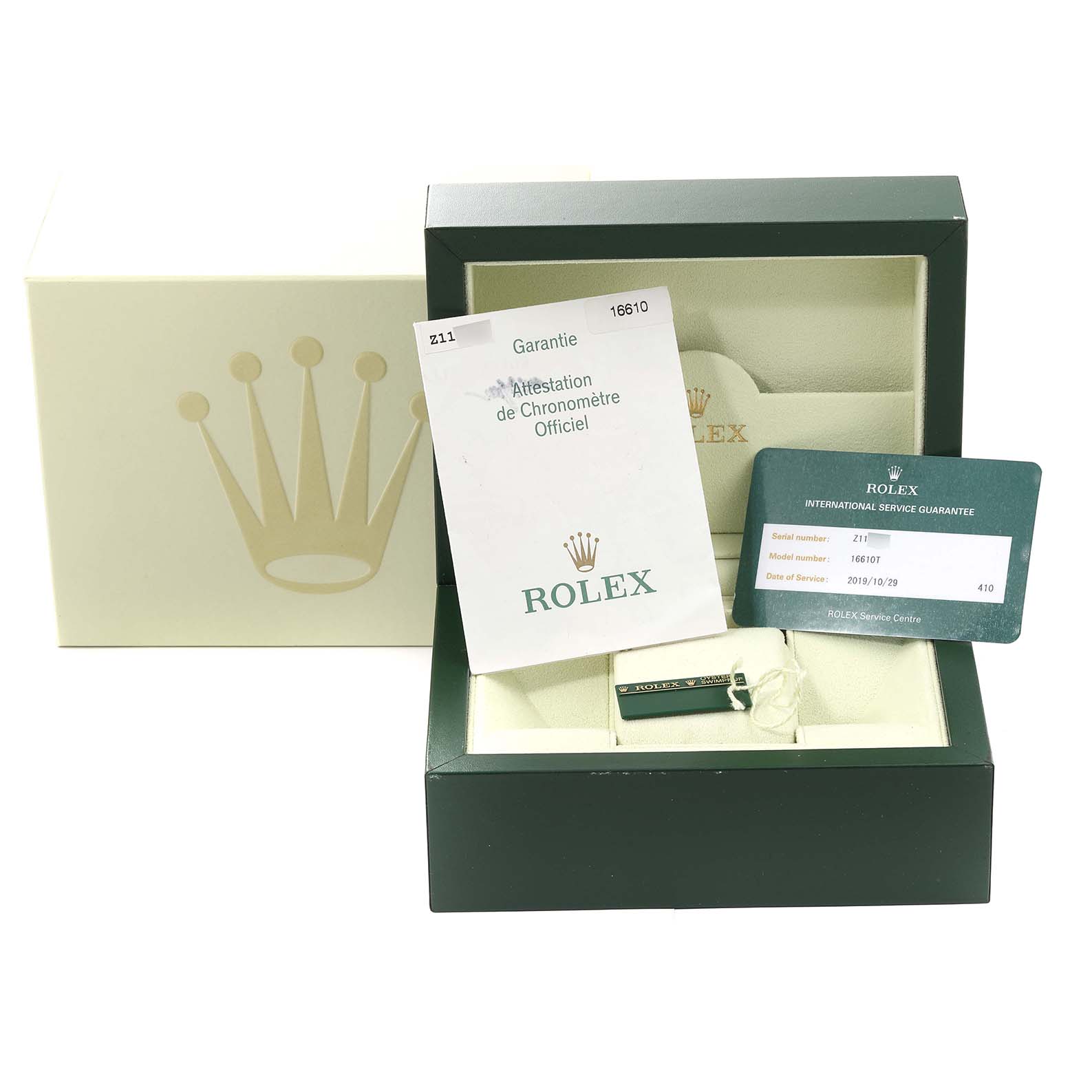 The image shows a Rolex Submariner 16610 Men
s Stainless Steel Black Dial 16610 Men
s Stainless Steel Black Dial watch box, warranty card, booklet, and tag from a frontal angle.